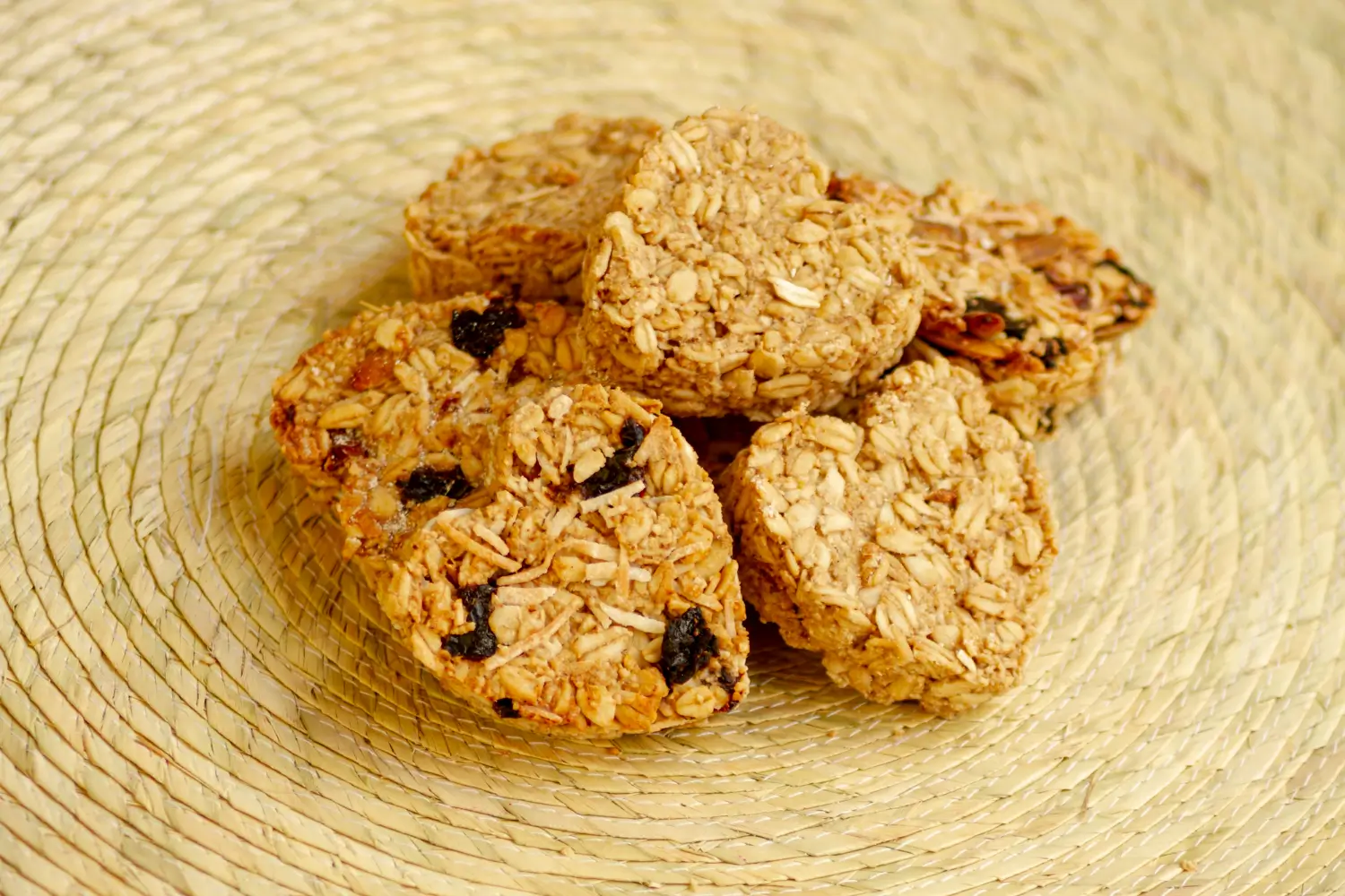 Heart-shaped oat protein cookies with dried fruits displayed on a woven mat - perfect for Protein Cookie Recipes.